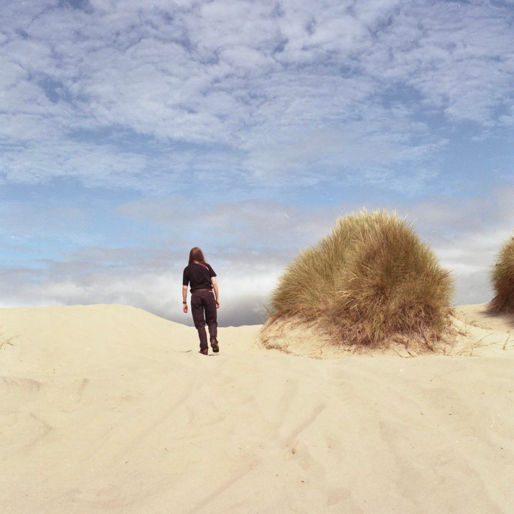 Person walking on sand dunes