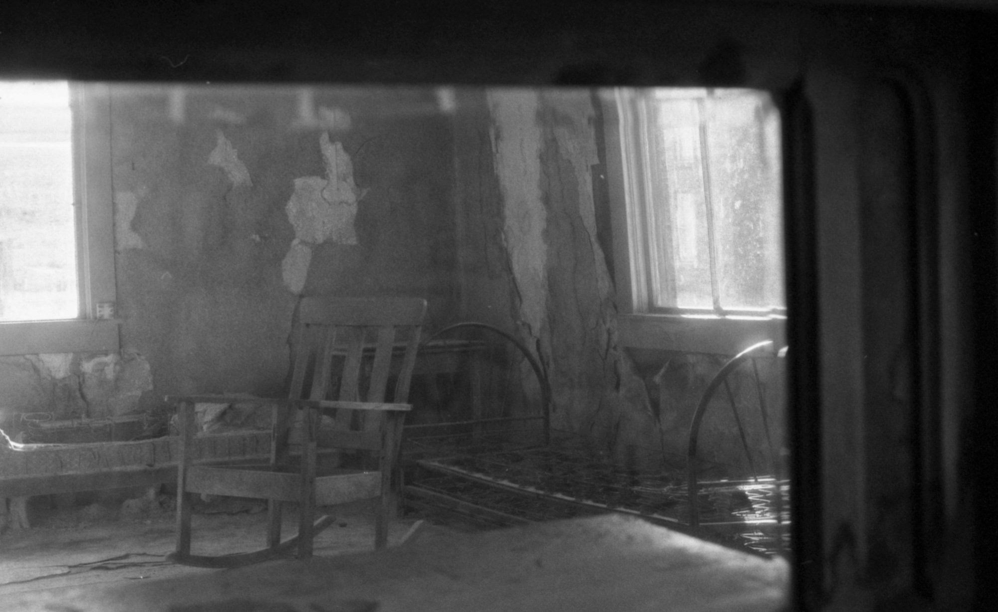 interior of an abandoned house - chair through window
